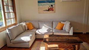a living room with a couch and a coffee table at Pet Friendly Riverside Classic With Wifi in Hawks Nest