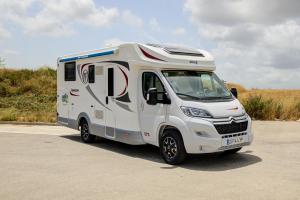 a white rv parked in a parking lot at Autocaravana Baron 573 in Cerdanyola del Valles