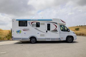 a white rv parked in a parking lot at Autocaravana Baron 573 in Cerdanyola del Valles