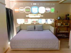 a bed with two pillows in a bedroom at Residence Hotel Kamoike in Kagoshima
