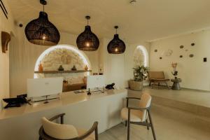 a salon with two chairs and a counter with lights at Opal Paros in Naousa