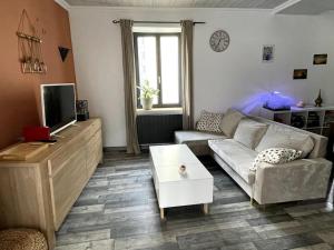 a living room with a couch and a coffee table at Appartement Royat bourg in Royat