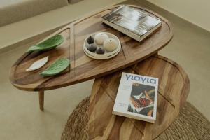 a wooden table with a bowl of eggs and a magazine at Opal Paros in Naousa