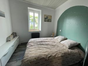 a bedroom with a large bed and a window at Appartement Royat bourg in Royat +13 photos