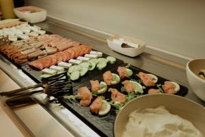 a buffet of food with sushi and other foods at Opal Paros in Naousa