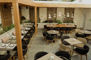 an empty dining room with tables and chairs at Opal Paros in Naousa