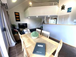 a dining room with a table with a book on it at Osprey Holiday Village Unit 113 2 Bedroom in Exmouth