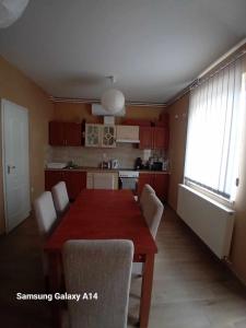 a kitchen with a table and chairs in a room at Kötél utcai vendégház in Balatonkeresztúr