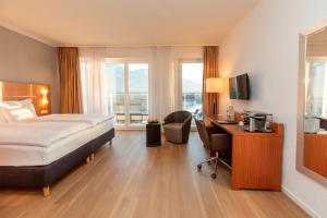 a hotel room with a bed and a desk at Hotel la Palma au Lac in Locarno