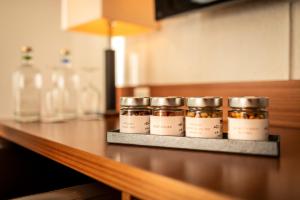 four jars of honey sitting on a counter at Hotel la Palma au Lac in Locarno