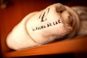 a white towel with the words lymaniaaniaaniaaniayss at Hotel la Palma au Lac in Locarno