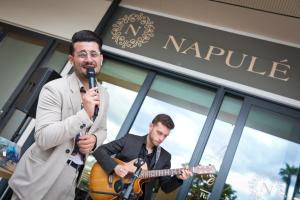 a man holding a microphone and a man playing guitar at Hotel la Palma au Lac in Locarno