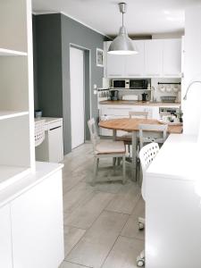 a kitchen and dining room with a table and chairs at Apartment Astina in Koper