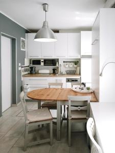 a kitchen with a wooden table and chairs at Apartment Astina in Koper