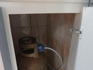 a bathroom with a shower with a hose at Ndouha House in Bafoussam +5 photos
