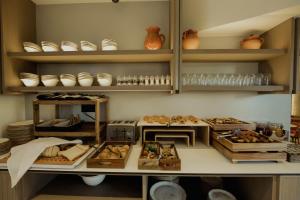 a kitchen filled with lots of food on shelves at Opal Paros in Naousa