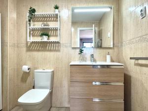 a bathroom with a toilet and a sink and a mirror at Beach Apartment, Torre Benagalbón in Torre de Benagalbón +11 photos