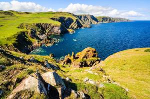 a view of a large body of water with rocks at Ebba Lodge in Eyemouth