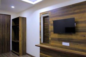 a room with a flat screen tv on a wall at Hotel KANDA CONTINENTAL 50 Mtr from golden temple in Amritsar