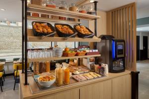 a buffet with various foods and drinks on shelves at Timhotel Paris Gare de l'Est in Paris