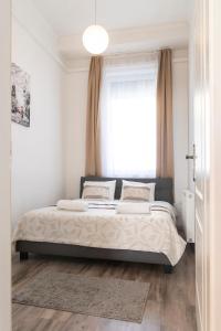 Posteľ alebo postele v izbe v ubytovaní Real Apartments Révay