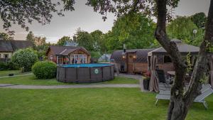 a backyard with a pool table and a house at Strazdu Māja in Jūrmala