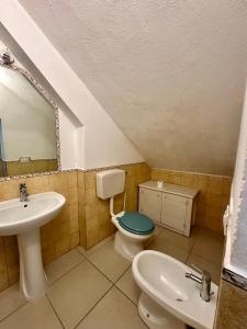 a bathroom with a sink and a toilet and a mirror at Appartamenti Dépendance Mariel in Orbetello +18 photos