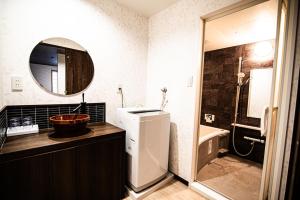 a bathroom with a sink and a toilet and a mirror at Hotel Amaranth Kyoto Gojo - Vacation STAY 19846v in Kyoto +47 photos