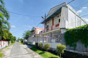 a building on the side of a street at Amira House Kisaran RedPartner in Kisaran +16 photos