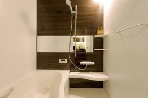 a bathroom with a tub and a sink and a shower at 静響の宿 Silent Echo Inn in Osaka +38 photos
