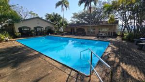a swimming pool in front of a house at Seaview Villa 26 in Margate