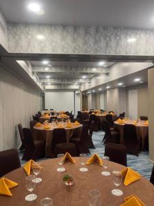 a conference room with tables and chairs with yellow napkins at Unisi Hotel Malioboro - Jogja Syariah in Yogyakarta
