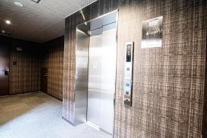 a elevator in a bathroom with tile walls at Hotel Amaranth Kyoto Gojo - Vacation STAY 19866v in Kyoto