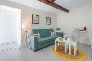 a living room with a green couch and a table at Host Wise - Solar de Pisões in Marco de Canavezes
