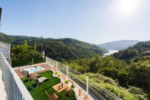 a balcony of a house with a view of the water at Host Wise - Solar de Pisões in Marco de Canavezes