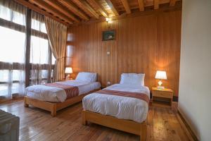 Postel nebo postele na pokoji v ubytování Hotel Ugyenling