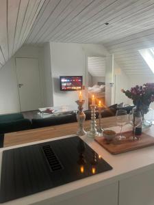 a living room with a table with candles and wine glasses at Scandinavian Haven in Mörarp
