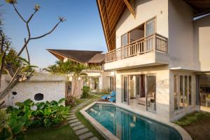 an exterior view of a house with a swimming pool at Adinda Balangan Beach Villa in Jimbaran