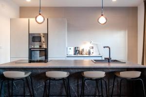 a kitchen with a large island with bar stools at Beachfront Villa Taris with Seaview in Privlaka