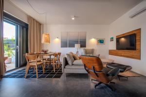 a living room with a couch and a table at Beachfront Villa Taris with Seaview in Privlaka