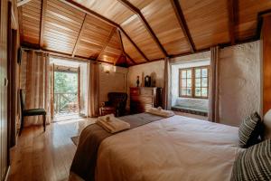 En eller flere senge i et værelse på HAGAH Alojamentos - Gerês