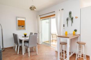 a kitchen and dining room with a table and chairs at Apartment Andorinha-pretty Holiday Home With Pool in Santa Luzia