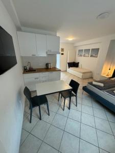 a kitchen and living room with a table and chairs at Cozy flat near Tivoli park with free parking in Ljubljana