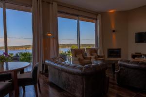 a living room with couches and a table and chairs at Montargil Monte Novo in Montargil