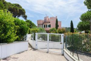 a white gate in front of a house at Villa Chioma by Mmega in Chioma