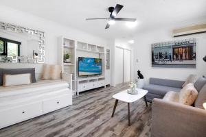a living room with a couch and a tv at Pets Paradise - Top location with FREE parking in Gold Coast