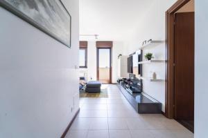 a room with a hallway with a living room at Certosa House - Milano in Milan