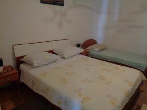 a bedroom with two beds and a bedskirts at Apartment Ivan in Sukošan