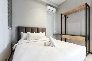 a bedroom with a white bed and a mirror at Urban Suites George Town in Jelutong