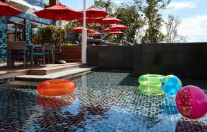 a swimming pool with colorful balls in the water at Amari Phuket in Patong Beach